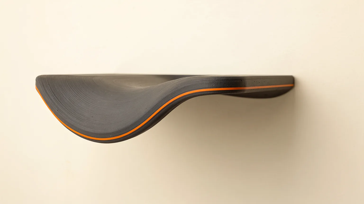 Illustration: a graphite printed shelf-like overhang with its underside drooping and wavy, with one orange layer line along the drooping edge