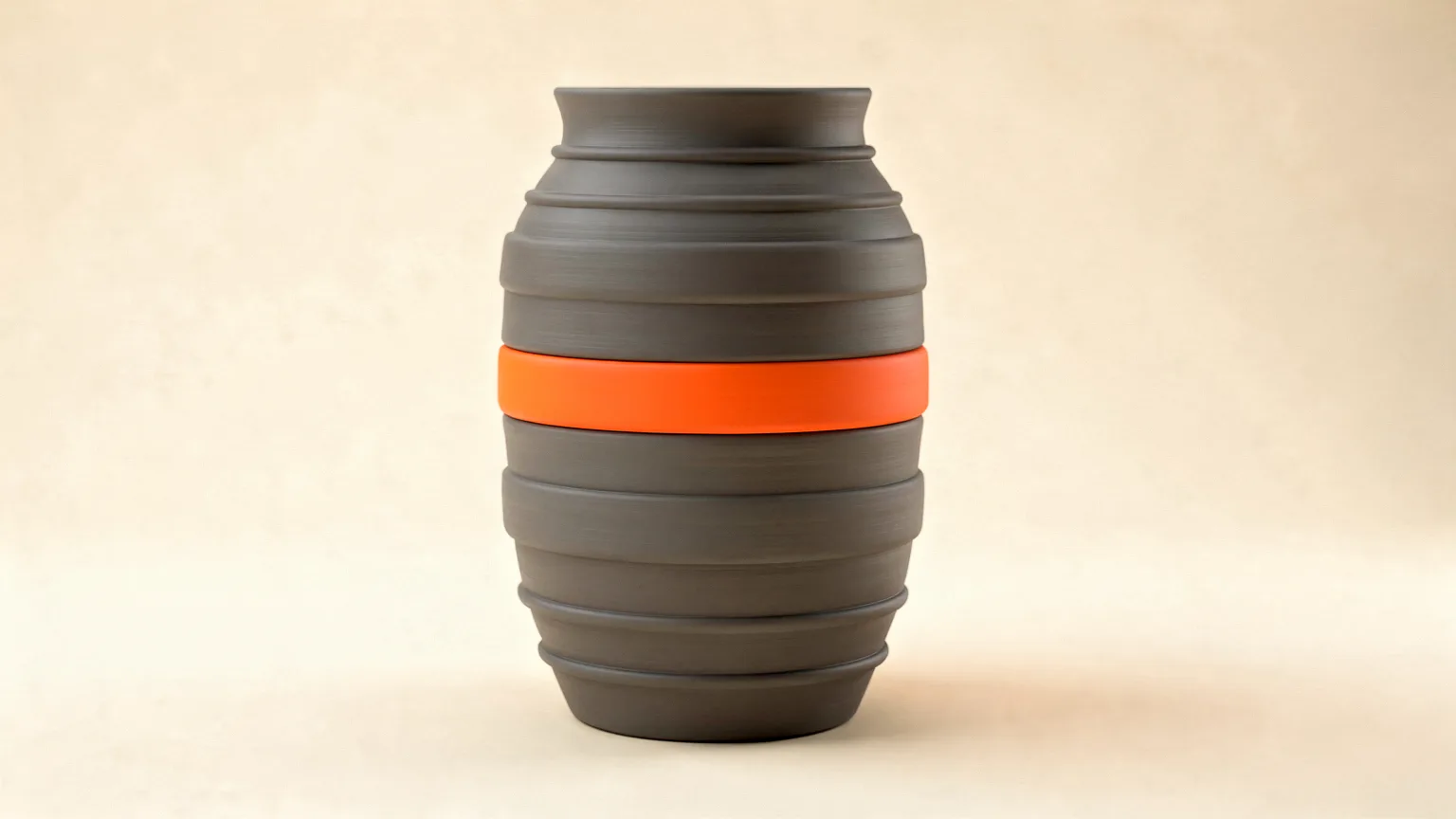 Illustration: a tall smooth graphite printed vase with evenly spaced horizontal bands visible along its height, one orange band among them, side view