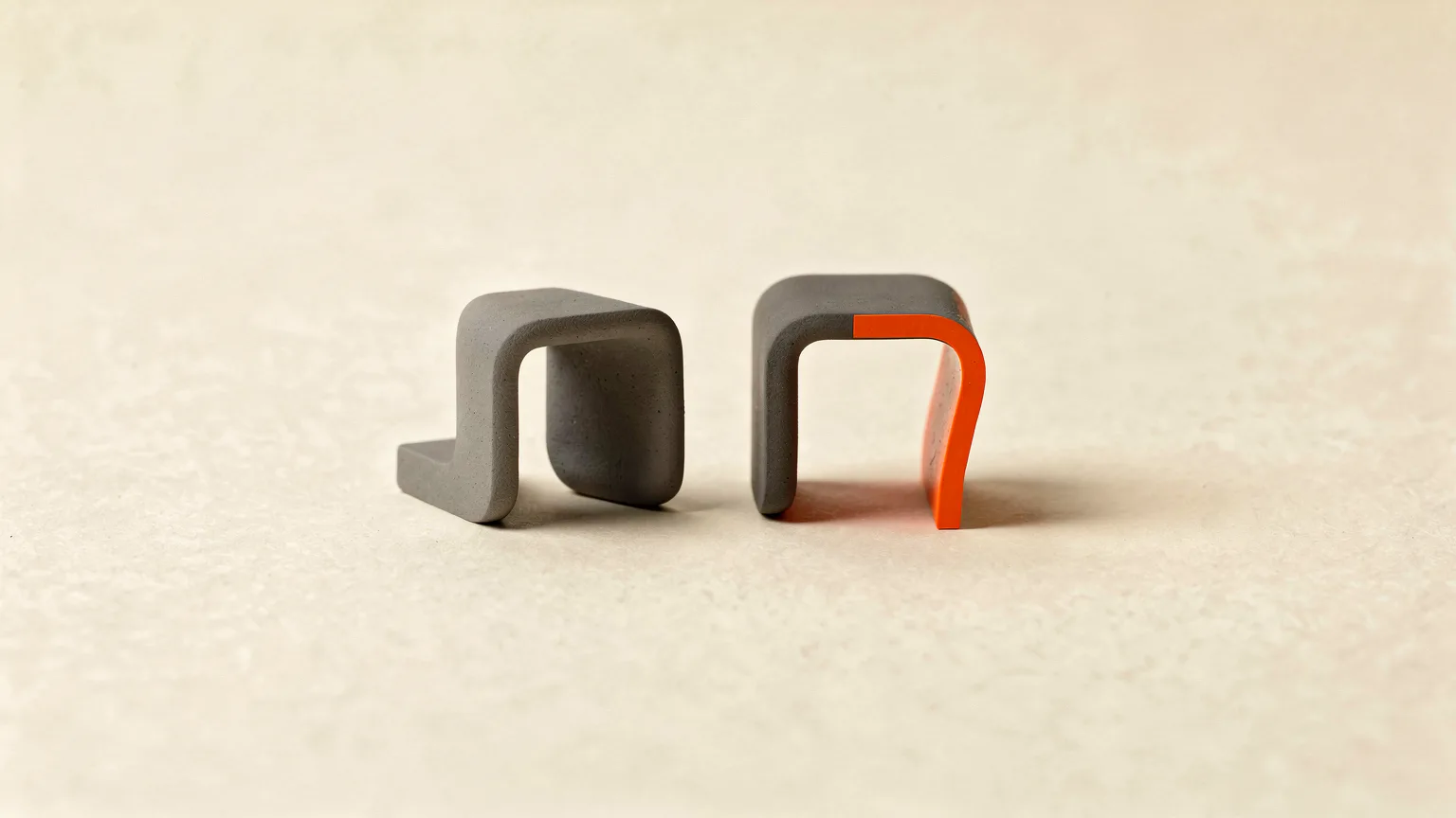 Illustration of two matching graphite brackets side by side, one with a bright orange warped edge