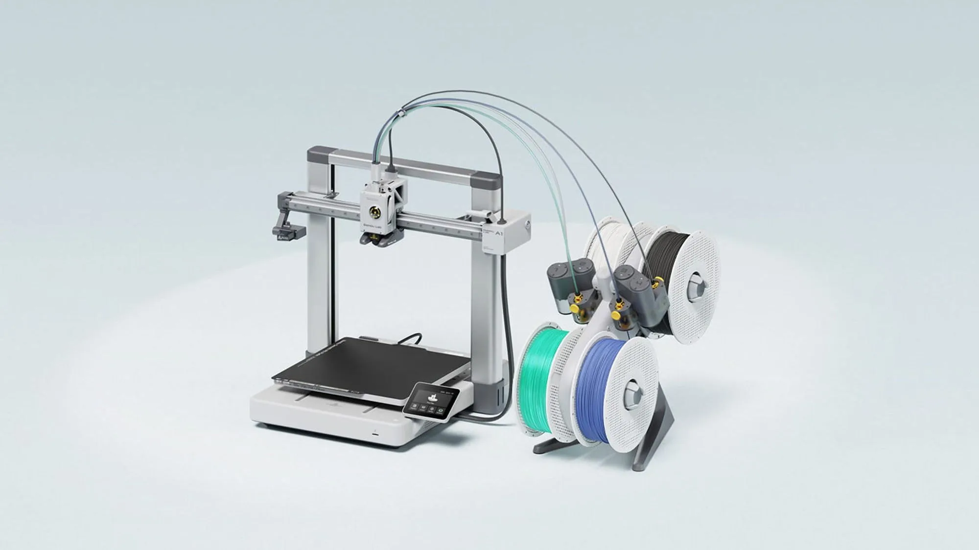 Bambu Lab A1 open-frame 3D printer with the AMS lite multi-colour filament feeder and green and blue spools on a pale blue background