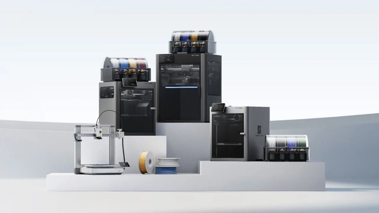 Bambu Lab 3D printer range, with several enclosed printers and AMS filament units stacked on white steps beside a smaller open-frame printer